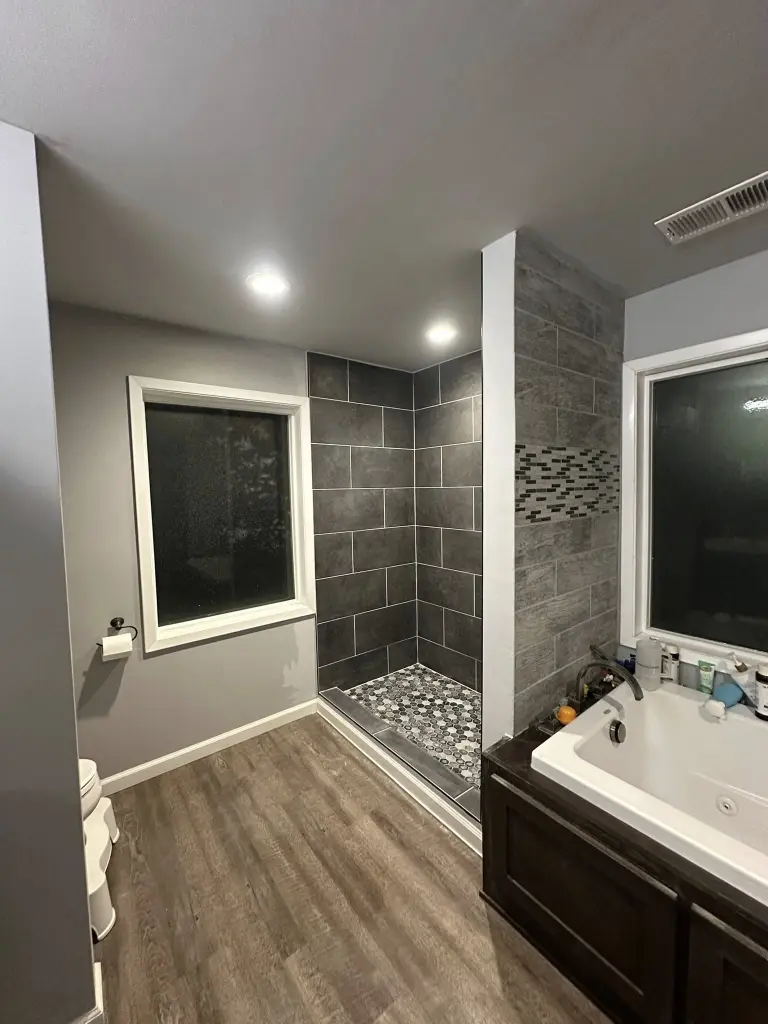 Finished bathroom after remediation showing mold cleanup results Gainesville FL with clean surfaces, shower tile, and fresh paint.