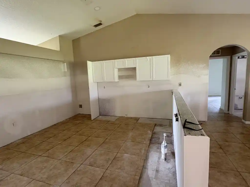 Kitchen after mold remediation showing clean walls and new drywall ready for renovation